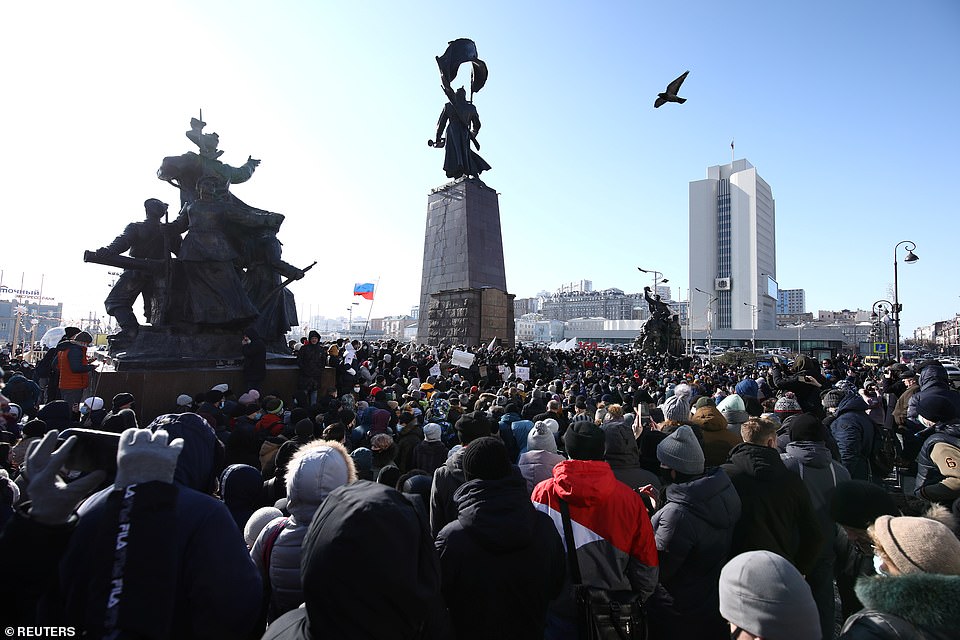 The Russian authorities told crowds that their action was unsanctioned and they faced detention unless they dispersed. Pictured: People take part in a rally in support of jailed Russian opposition leader Alexei Navalny in Vladivostok