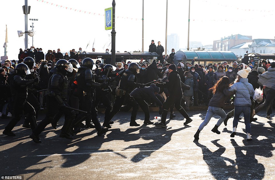 Pictured: Protesters run away from law enforcement officers during a rally in support of jailed Russian opposition leader Alexei Navalny in Vladivostok, Russia January 23. Around 250 people have been reportedly arrested during the protests