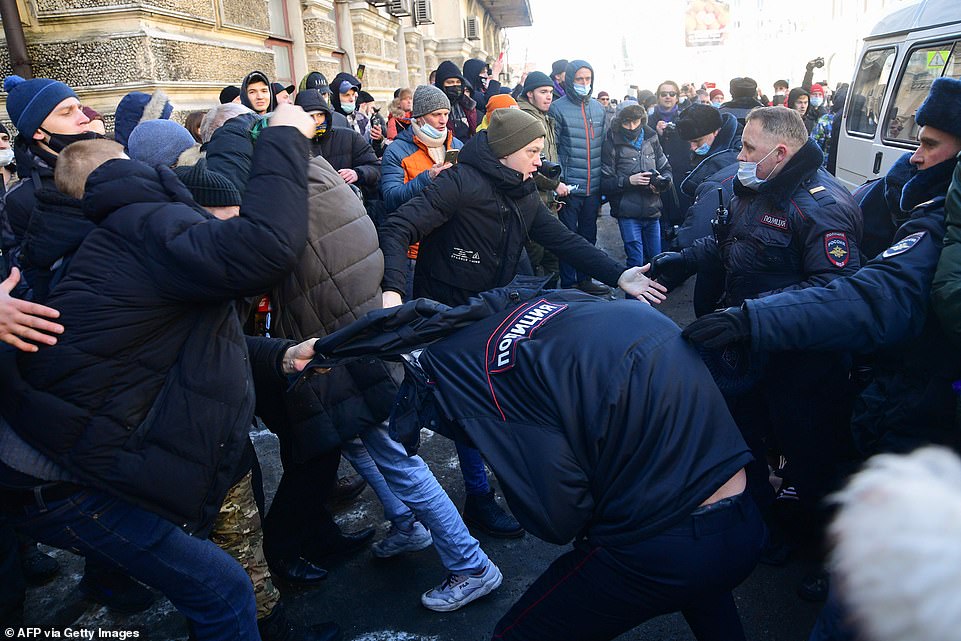 Pictured: Demonstrators clash with police during a rally in support of jailed opposition leader Alexei Navalny in the far eastern city of Vladivostok on January 23