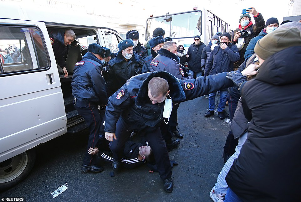 Law enforcement officers restrain a protester during a rally in support of jailed Russian opposition leader Alexei Navalny in Vladivostok, Russia January 23