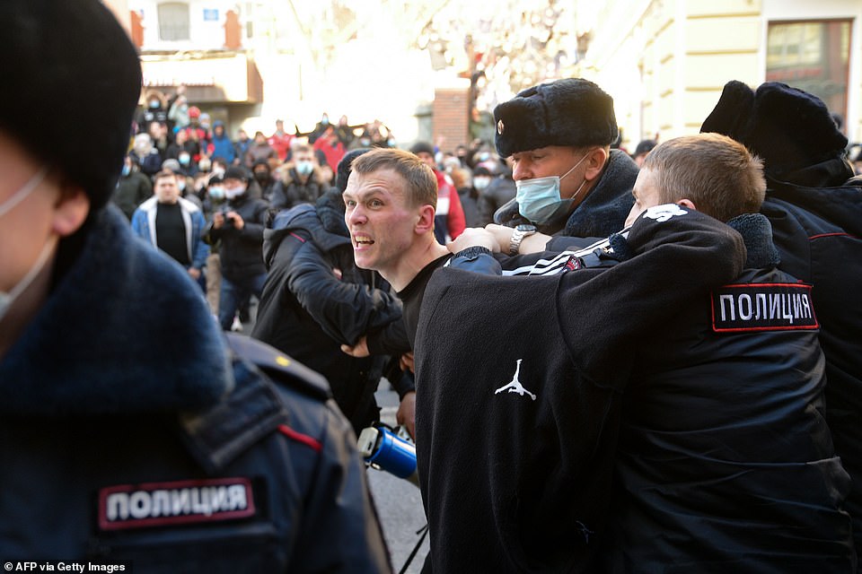 Pictured: Police officers detain a man during a rally in support of jailed opposition leader Alexei Navalny in the far eastern city of Vladivostok on January 23