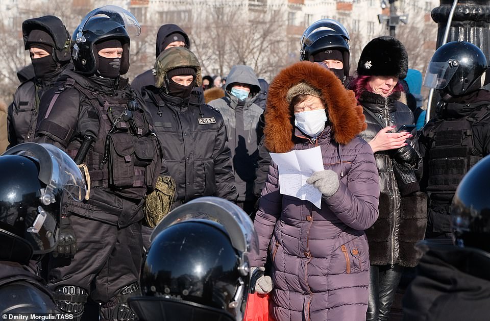 A woman is surrounded by riot police during January 23 protests against the arrest of Alexei N
avalny, who was been detained upon his return to Russia