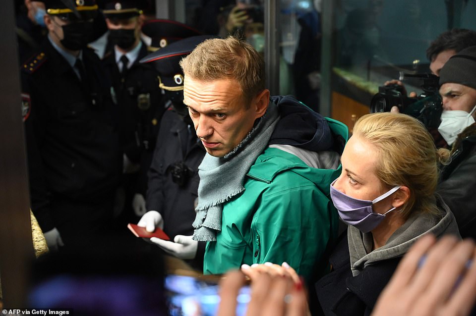 Alexei Navalny with his wife Yulia at Moscow's Sheremetyevo airport on Sunday where he was arrested after returning to Russia from Germany