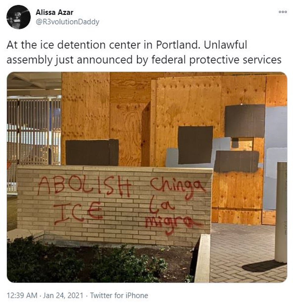 Protesters spray painted the side of the ICE facility, which was boarded up for security