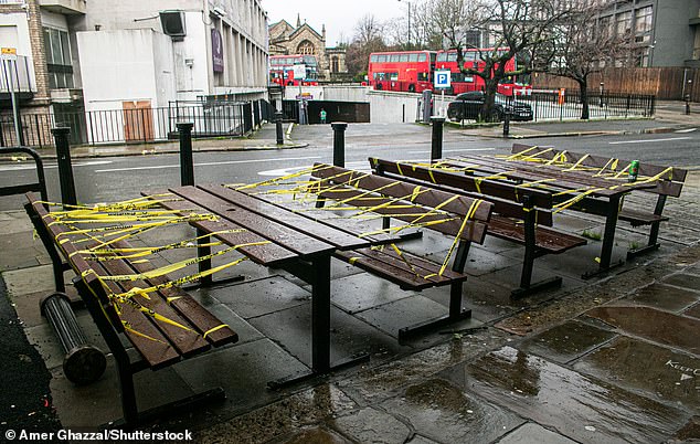 The move does not mean lockdown has been extended, but means the powers are in place should the Government decide to push back its current timetable. Pictured: A set of taped-off benches outside a pub in London