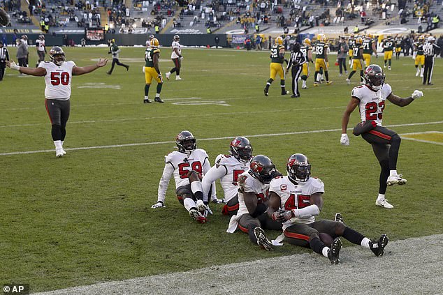 The Tampa Bay Bucaneers celebrate after recovering a fumble by Packers' Aaron Jones