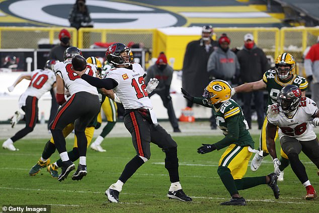 Brady throws an interception under pressure from Darnell Savage of the Green Bay Packers