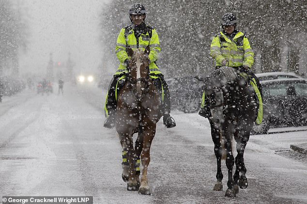 Police forces across the country have been slammed for threatening snowball fighters with £200 fines as an Arctic ice blast brought six inches of the white stuff to the UK on Sunday. Pictured: Police in a snow-covered Greenwich park