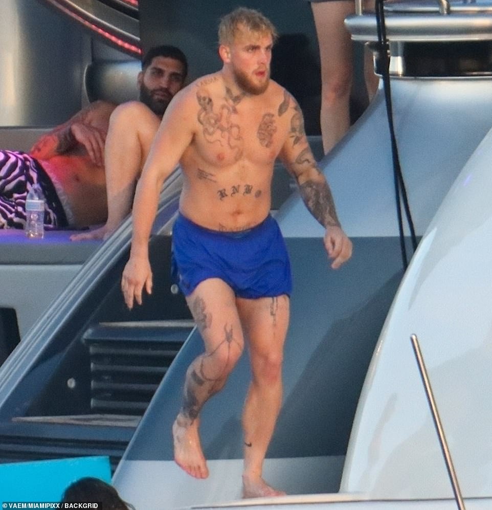 The tattooed, 6ft blonde, who recently relocated from Los Angeles to Miami, was shirtless and wearing blue swim trunks
