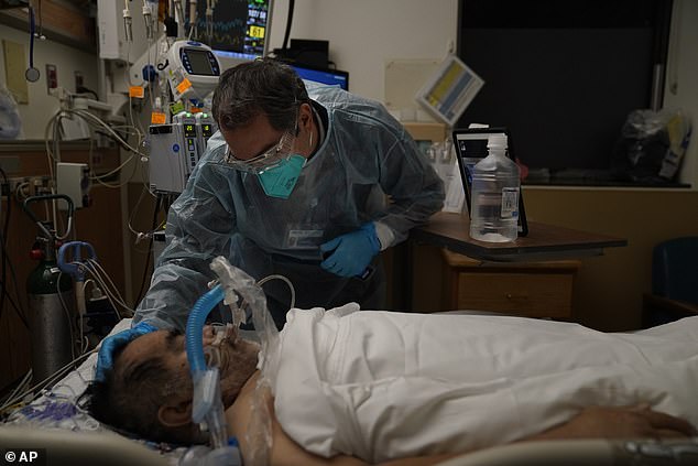 Patients smoking at least one pack per day for more than 30 years were 2.25 times more likely to be hospitalized and 1.9 times more likely from the virus than those who had never smoked before. Pictured: Chaplain Kevin Deegan places his hand on the head of a COVID-19 patient while praying for him at Providence Holy Cross Medical Center in Los Angeles, January 9, 2021