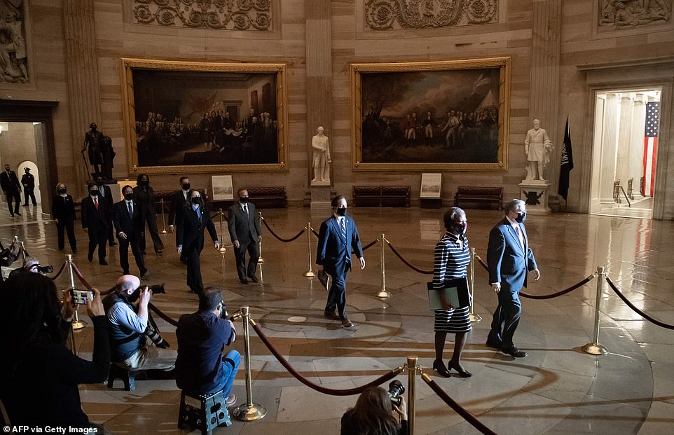 Here they go: The House impeachment managers make their way through Statuary Hall towards the Senate