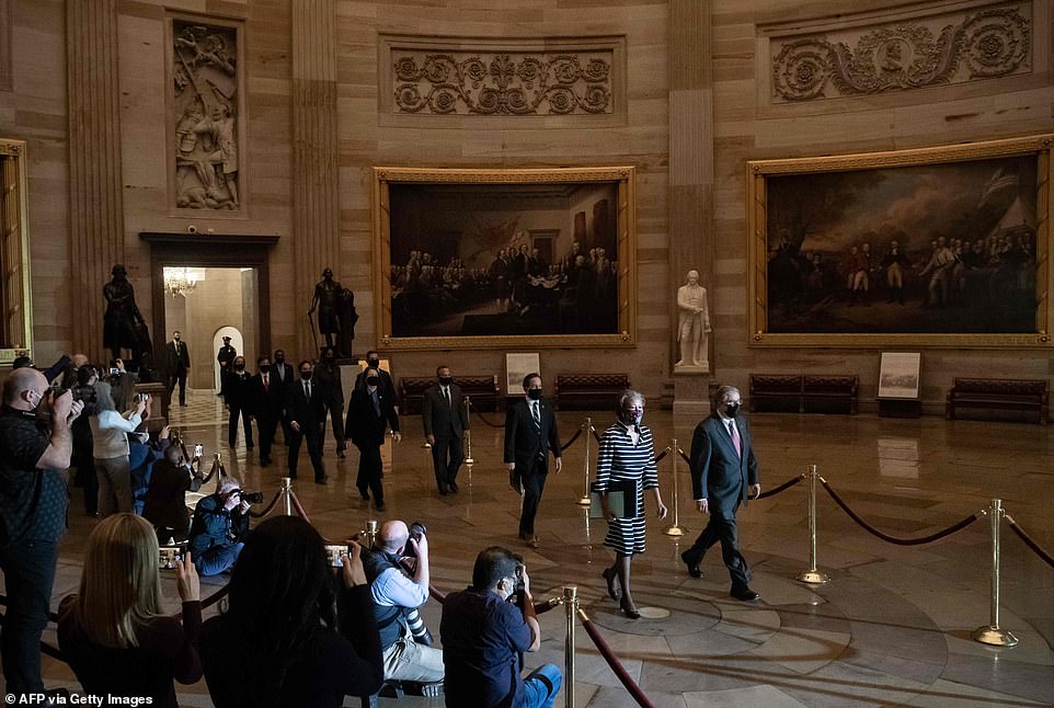 Moment of history: The impeachment managers cross through Statuary Hall towards the Senate