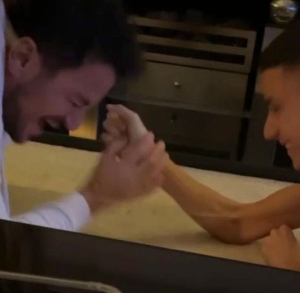 Peter and Junior Andre arm-wrestle