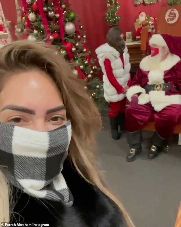Business trip: Her daughter also got a chance to meet Santa at the tourist attraction, though she admitted earlier in the video that 'Santa isn't real.'