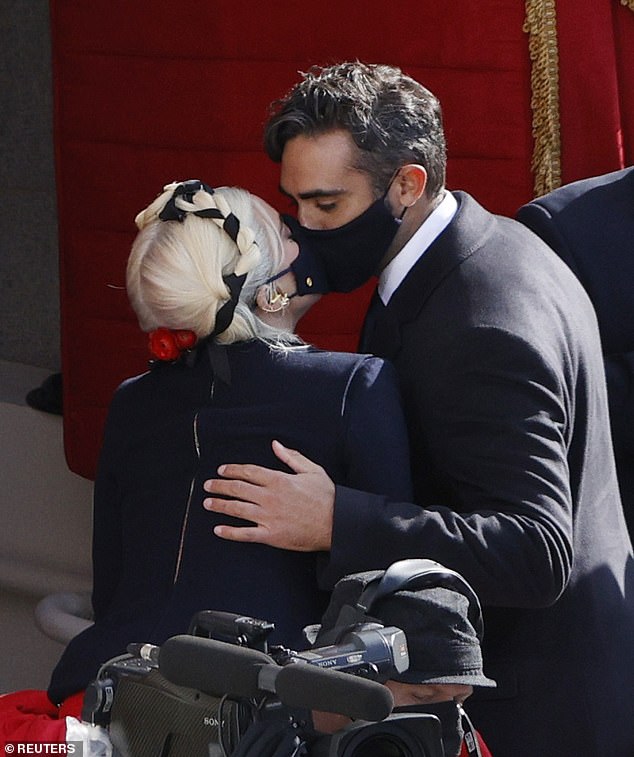 Sweet: Gaga brought as her date as she performed The Star-Spangled Banner before watching Joe Biden and Kamala Harris get sworn in as president and vice president, respectively