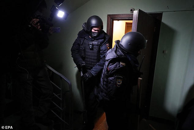 Policemen leave the flat of opposition leader Alexei Navalny in Moscow, Russia today. The property is occupied at present by Navalny's wife Yulia, as her husband was jailed on return to Russia for allegedly breaching the terms of a suspended sentence
