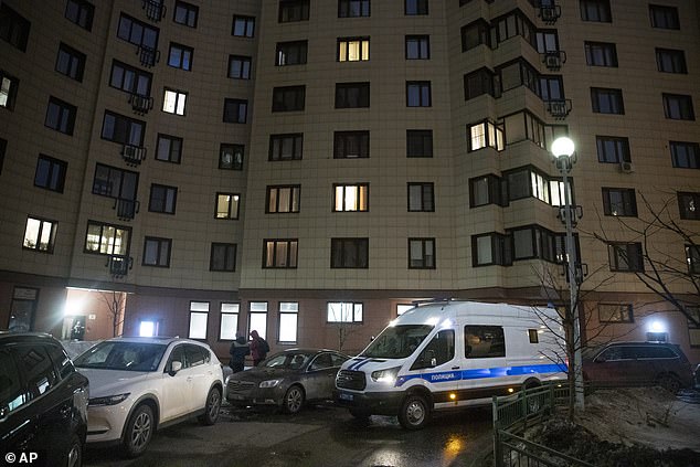 A Russian police van is parked outside of the Moscow apartment building of jailed opposition leader Navalny today. Police searched the dissident's properties as part of a criminal probe into whether organisers of nationwide rallies on Saturday breached coronavirus restrictions