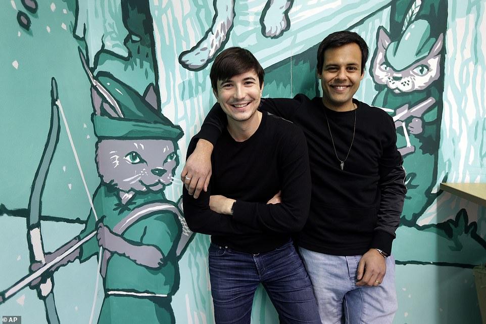 Robinhood co-founders Vlad Tenev, left, and Baiju Bhatt pose at company headquarters in Palo Alto