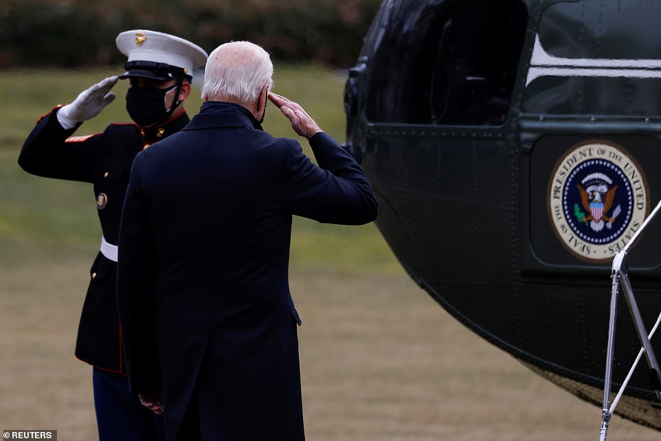 President Biden salutes the Marine before he boards Marine One