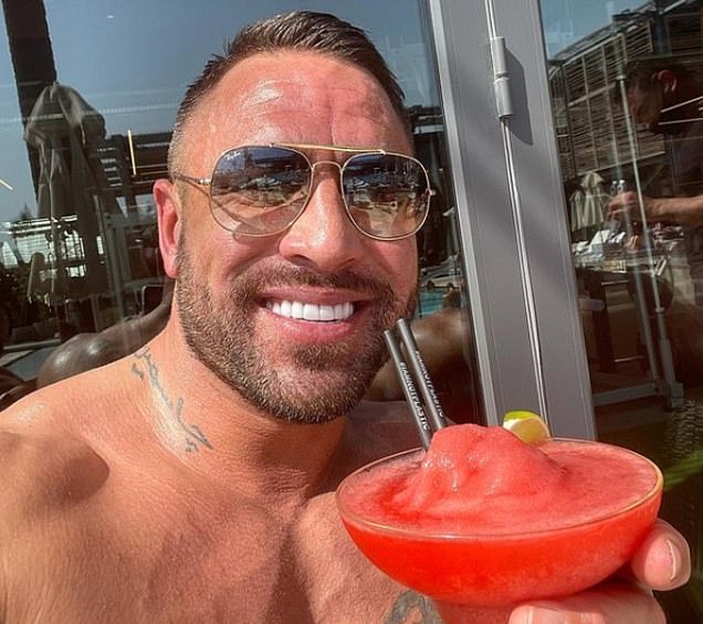 Fun: Influencer Gav Gibson posted a photograph of him with a drink at Train Beach Club at La Mer in Dubai on Friday with the caption: 'UK government, you can't come home. Me, cheers'