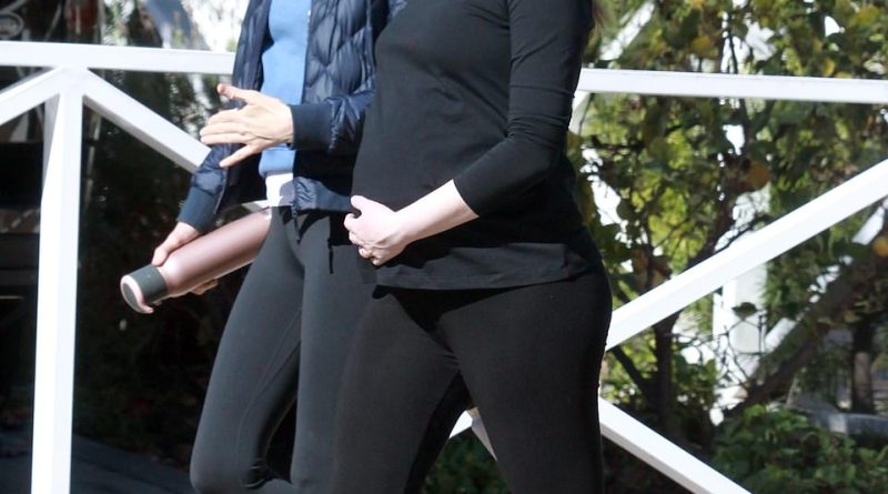Emma Stone is spotted lovingly cradling her large belly