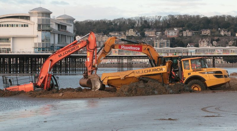 Got that sinking feeling! Rescue mission fails as tide swamps digger that got stuck on a beach