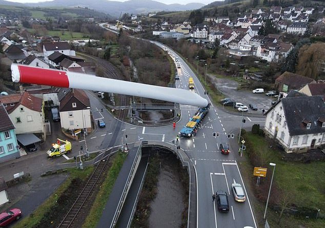 Skilled hauliers negotiate huge 220ft rotor blades through tiny villages and narrow roads 