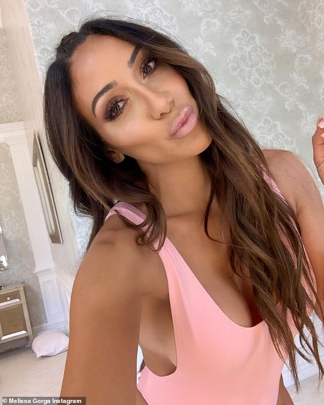 Heating up: The 41-year-old reality star looked ready for the summer while wearing an electric pink swimsuit as she took a few selfies for her two million followers