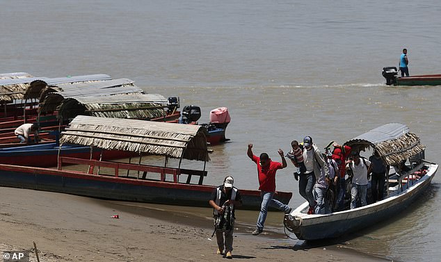 Migrants cross over the Usumacinta River from Guatemala into Mexico