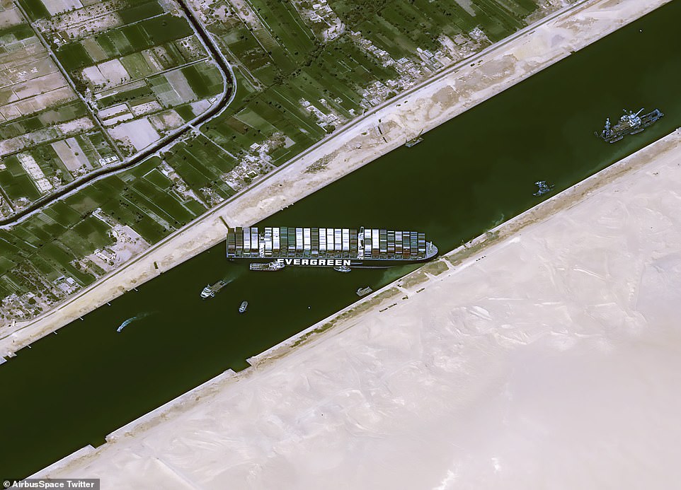 Satellite images taken today reveal the Ever Given - leased by shipping firm Evergreen - is still stranded in much the same position it was left on Tuesday after crashing