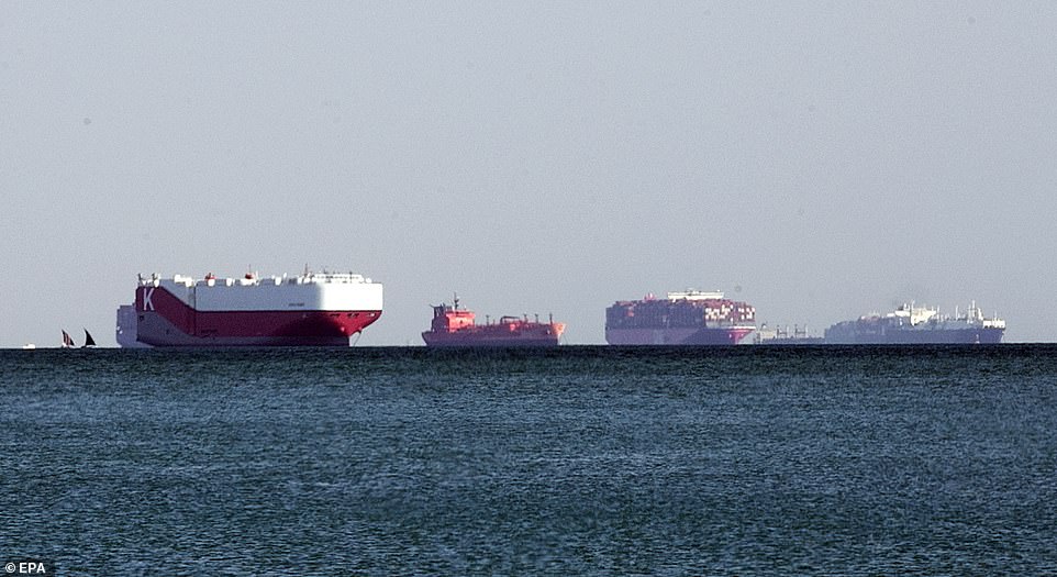 Ships are anchored outside the Suez Canal in Ismailia, Egypt, wait to be able to pass through the canal after it was blocked