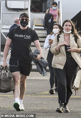 Flight fashion: Paul appeared Covid-safe as he donned a black mask during his flight from the rural town located in the far west of New South Wales
