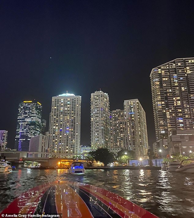 Starry night: Both Scott and Amelia shared this snap of the Miami skyline from their motorboat on their respective social media accounts