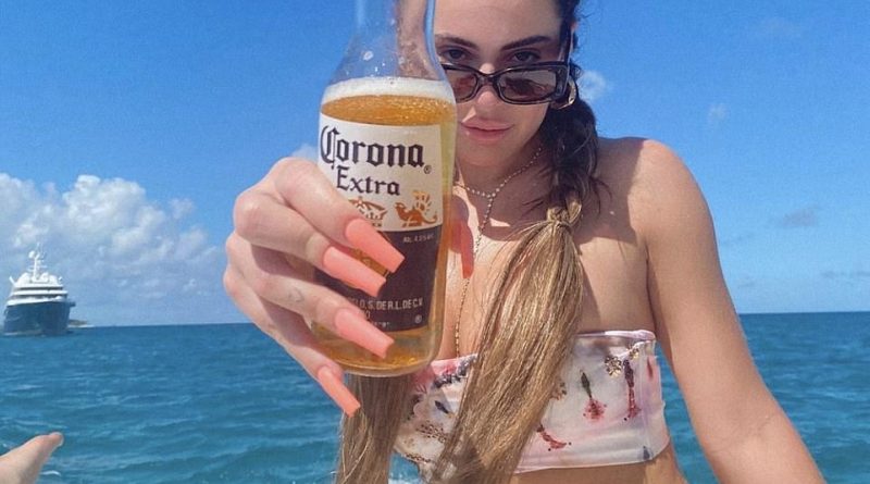 Kim Zolciak’s mini-me daughter Brielle Biermann holds up a Corona beer