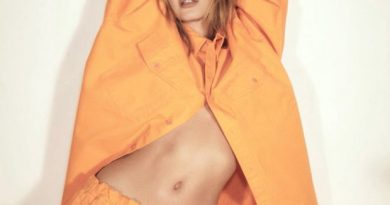 Hailey Bieber poses sensually in orange Balenciaga sweatsuit for Vogue Brasil