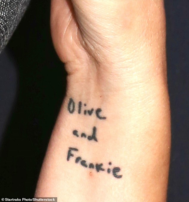 So sweet: One piece of ink near her elbow is of a bird, while another bit of body art around her wrist is the names of her daughters Olive, eight, and Frankie, seven