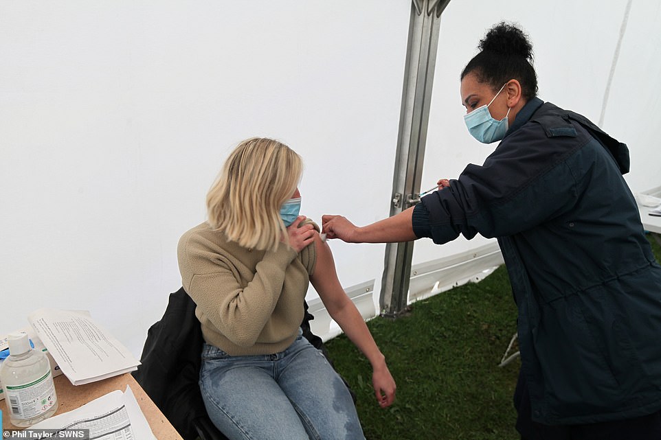 A healthcare worker administers a coronavirus injection as hundreds arrive to the pop-up centre today
