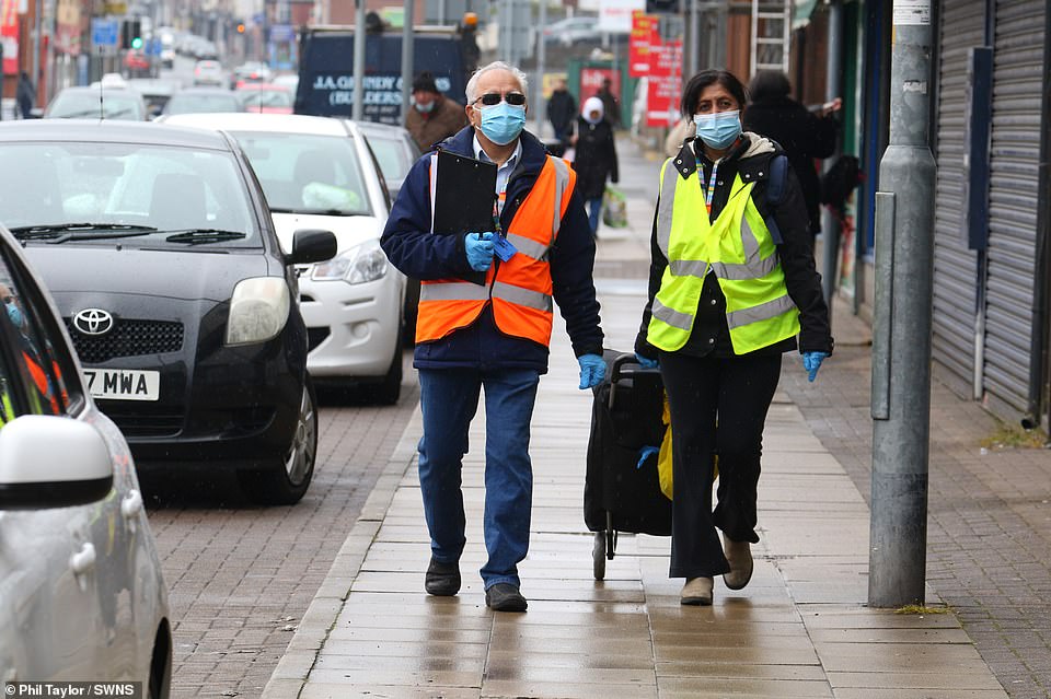 Bolton Council workers distributing surge Covid testing kits to shops in the Daubhill area of Bolton, Lancashire, today