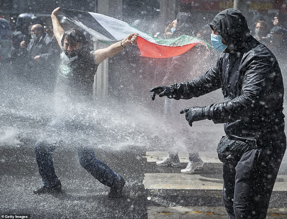 PARIS: Marches in support of Palestinians in the Gaza Strip were also held today in a dozen French cities, but the focus was on Paris, where riot police got ready as organizers said they would defy a ban on the protest. Pictured, Protesters face water cannons in Paris on Saturday
