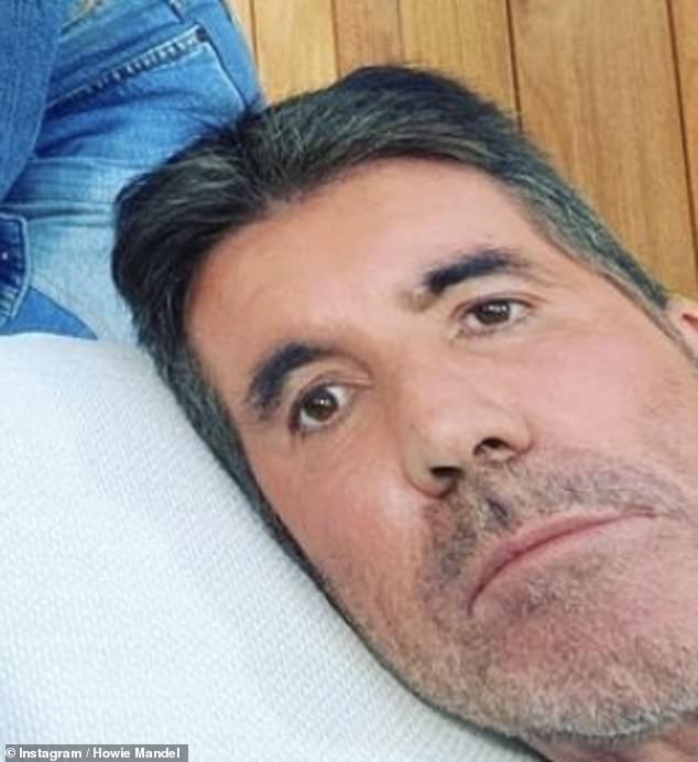 Alright there, Simon? Some people joked that the music mogul, 61, looked like a 'cardboard cutout' and even pondered whether he'd been 'Photoshopped' into the frame