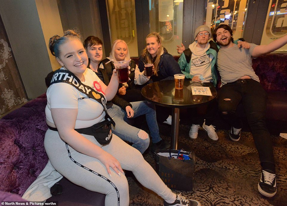 From Monday, pubs, restaurants and cafes can serve customers indoors, cinemas and hotels can reopen and people can embrace loved ones from other households for the first time in more than a year. Pictured: Revellers in Newcastle's Switch Bar among the first in the country to enjoy indoor drinking for the first time this year as bars reopen seconds after midnight this morning