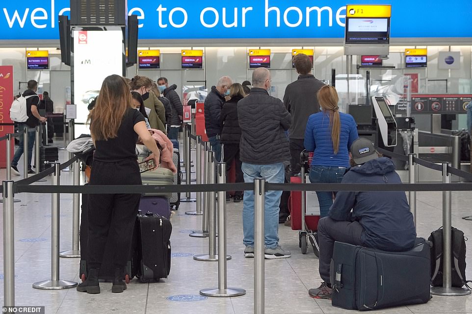 Passengers queueing at check-in at Terminal 5 in Heathrow Airport as the global travel ban is lifted by the Government