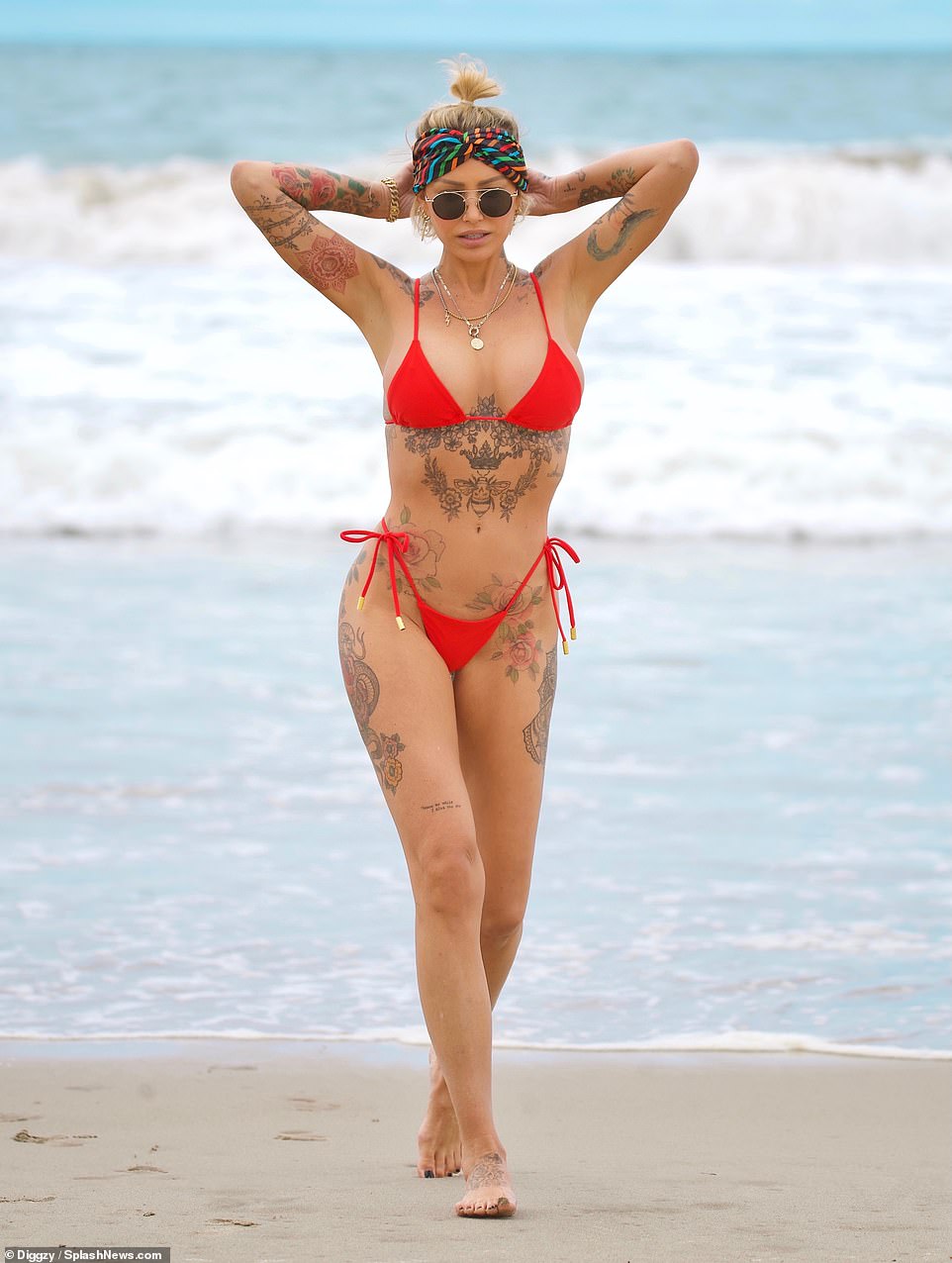 Va va voom: Tina showed off her ample assets in the tiny red string bikini as her bountiful cleavage and pert derriere were on full display