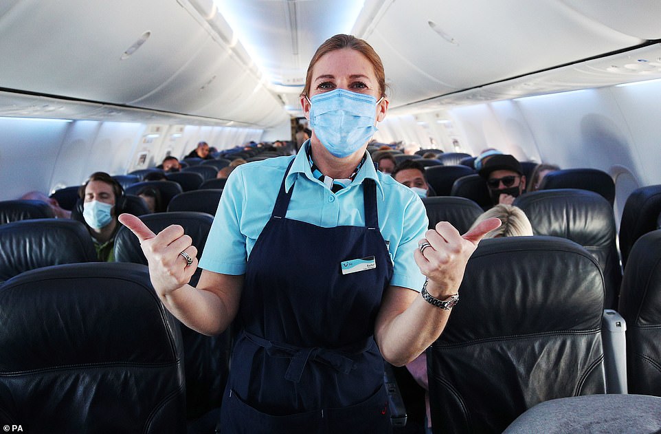 Staff and passengers onboard an early morning TUI flight to Madeira, one of the few green list destinations where people visiting from England will now not need to quarantine on their return. Issue date: Monday May 17