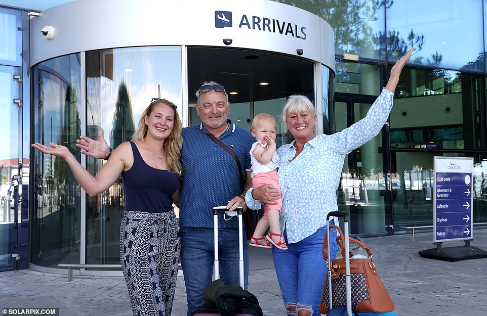Grandparents David and Lynne Wilson meet her daughter Kelly Dolan and baby Gabriella at the airport in Gibraltar on the day global travel restrictions are eased