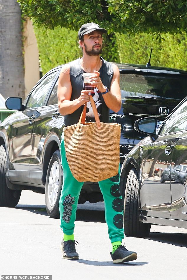 Looking good! Ryan picked up flowers and presents in a pair of teal sweatpants, a cropped tank and a vest