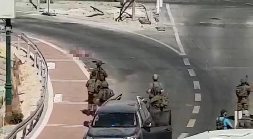 A second video taken by a witness shortly afterwards shows her lying face down in the road as an Israeli soldier kicks a rifle from out beneath her while others train their sights on her dead body. None of the troops were wounded in the incident - the second attempted terror attack near the majority Palestinian city of Hebron in as many days.