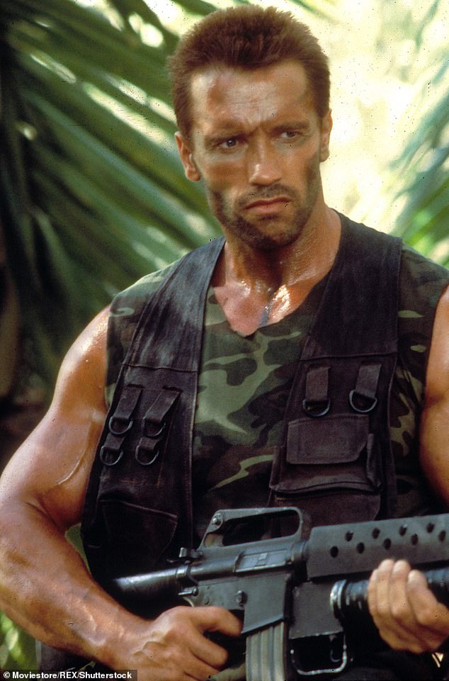 Dad in the early days: Schwarzenegger in his 1987 film Predator as the leader of an elite paramilitary rescue team on a mission to save hostages in guerrilla-held territory in Central America