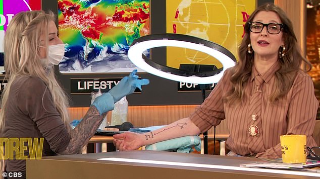 Making it happen: Drew Barrymore got a new tattoo applied to her right forearm on this Thursday's episode of her talk show