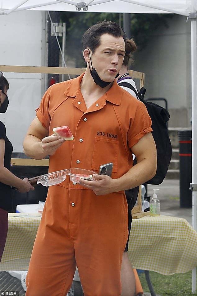 Quite a different jumpsuit: Taron Egerton was seen in an orange prison jumpsuit in the first photos from the New Orleans, Louisiana set of In With The Devil on Tuesday